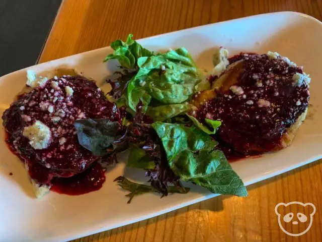 Plate of pierogis with salad. 