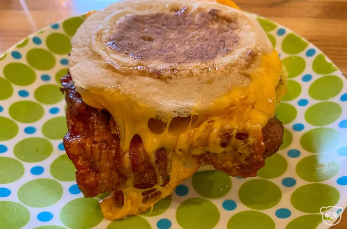 Breakfast sandwich on a spotted plate. 