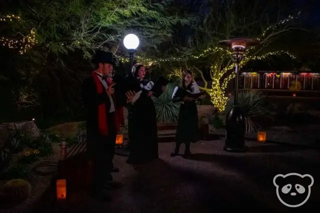 One male and two female Christmas carolers at the Desert Botanical Garden.