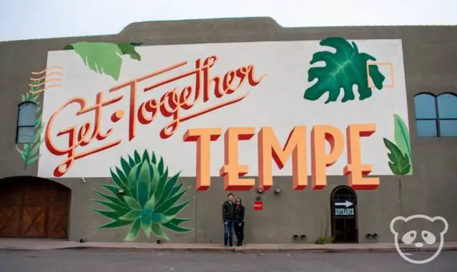 Us posing in front of a mural that says "Get Together Tempe."