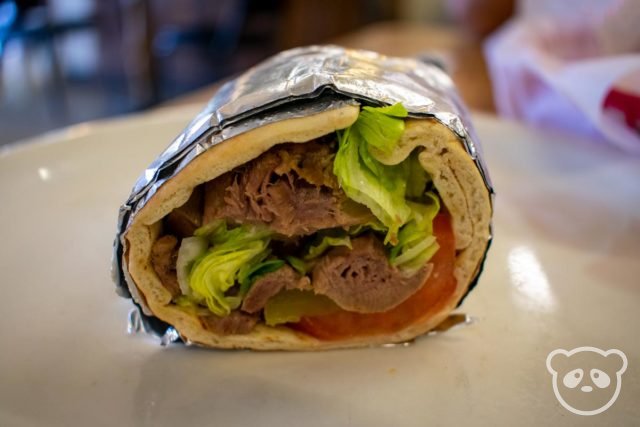 Half of a lamb tongue sandwich wrap in foil.