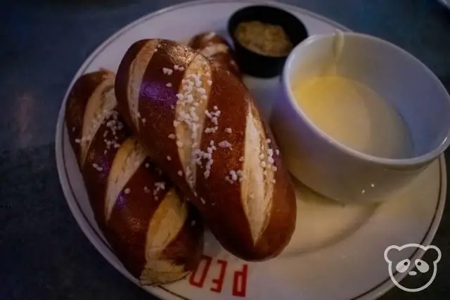 Pretzel rolls with a side of beer cheese and mustard dip.