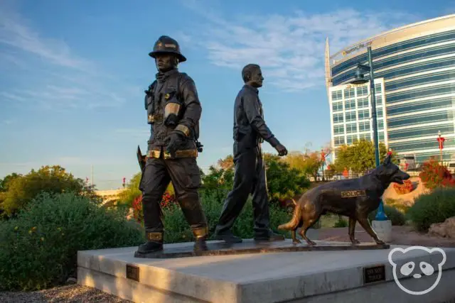 Statue of a firefighter, policeman, and police dog. 