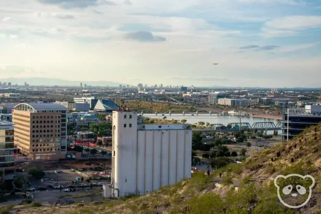 View of Hayden Mill, Phoenix Sky Harbor International Airport with a plane about to land, and the trail from the overlook just below the "A" on "A" Mountain.
