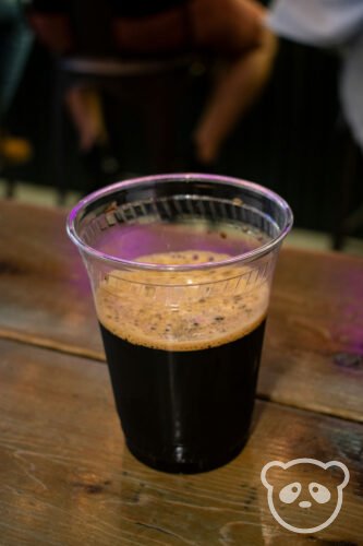 Plastic cup with beer on the table. 