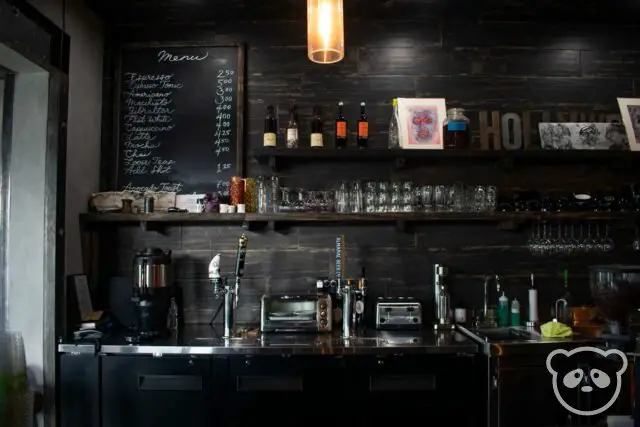 Barista bar with menu and glasses at a cafe. 