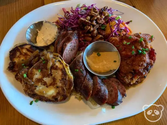 Plate of Polish food including Polish sausages, cabbage rolls, and pierogis. 