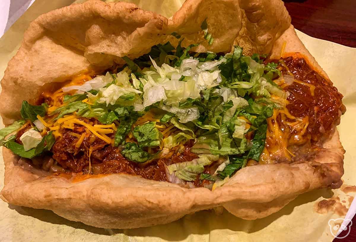 Native taco with fry bread, beef, shredded lettuce, and cheese. 