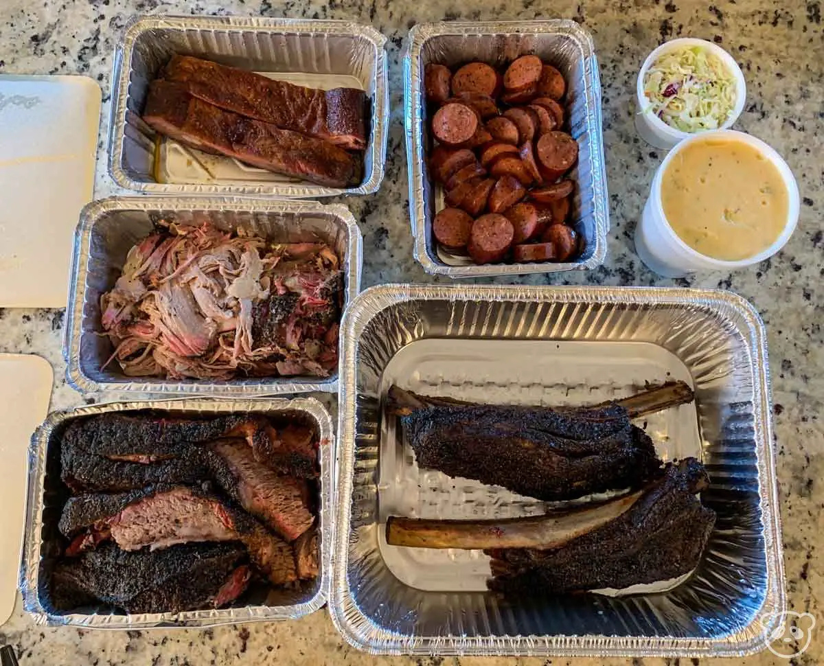 Food we got from Little Miss BBQ in foil takeout trays. 