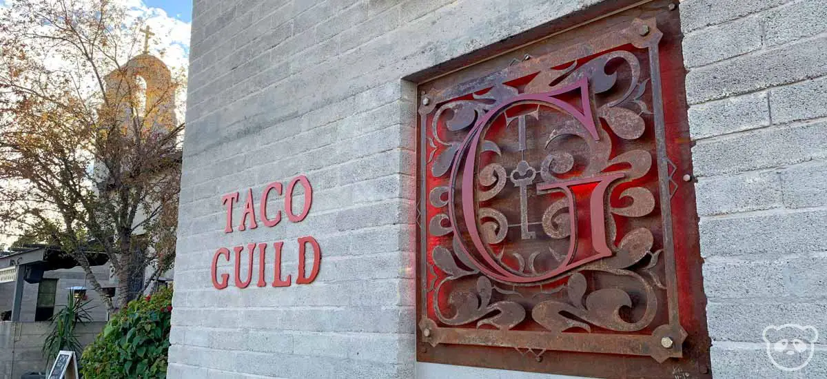 The outside of the Taco Guild restaurant building with Taco Guild sign.