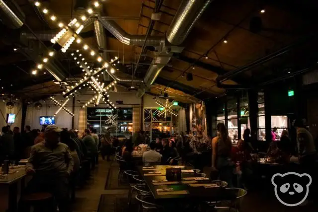 Interior of Culinary Dropout restaurant with bar counter and dining tables. 