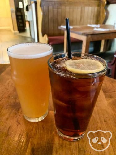 Beer and iced tea on the table top.