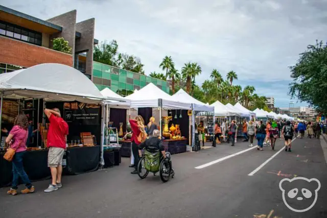 People walking down the street past the stalls at Tempe Festival of the Arts