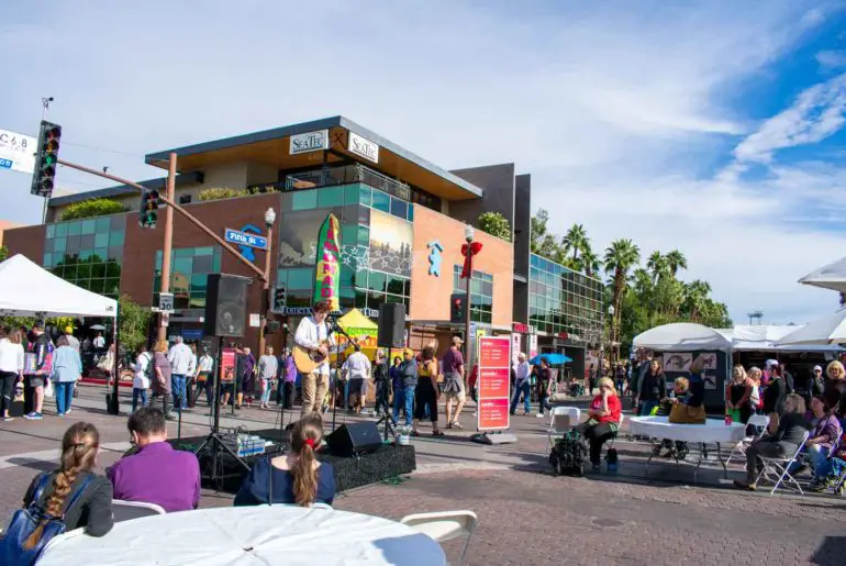 Tempe Festival of the Arts: Top Things to Do, Everything You Need to Know Performance on the stage at an art festival with visitors throughout.