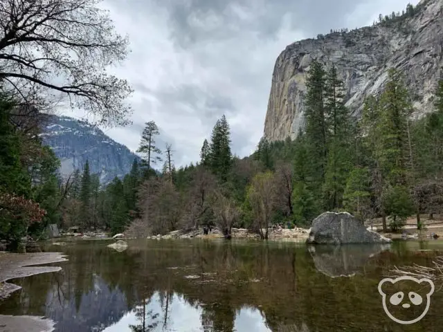 granite mountain landscape with trees and lake