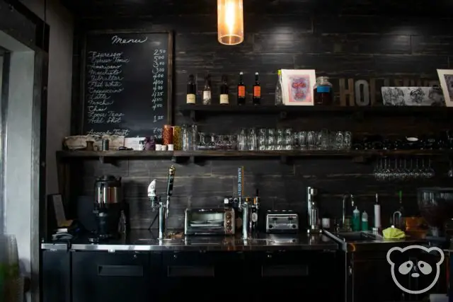 Barista bar with menu and glasses at a cafe.