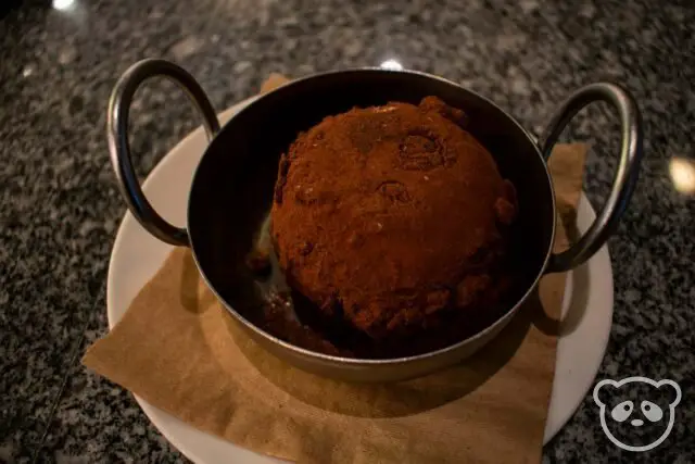 Chocolate tartufo in a tin basket looking dish. 