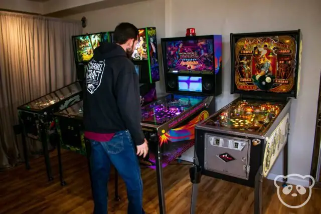 Man playing on pinball machine