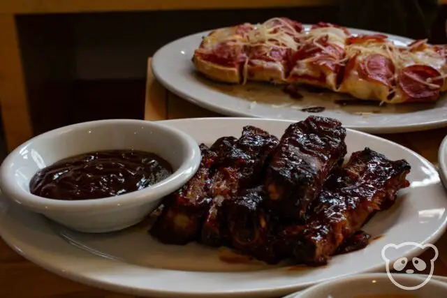 Ribs with barbecue sauce and garlic bread pepperoni pizza. 